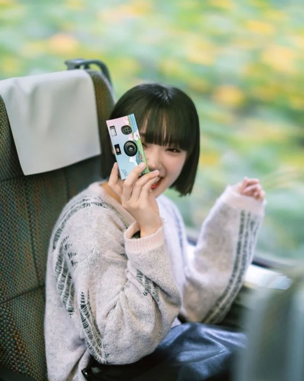 インスタントカメラを構える女性の写真
